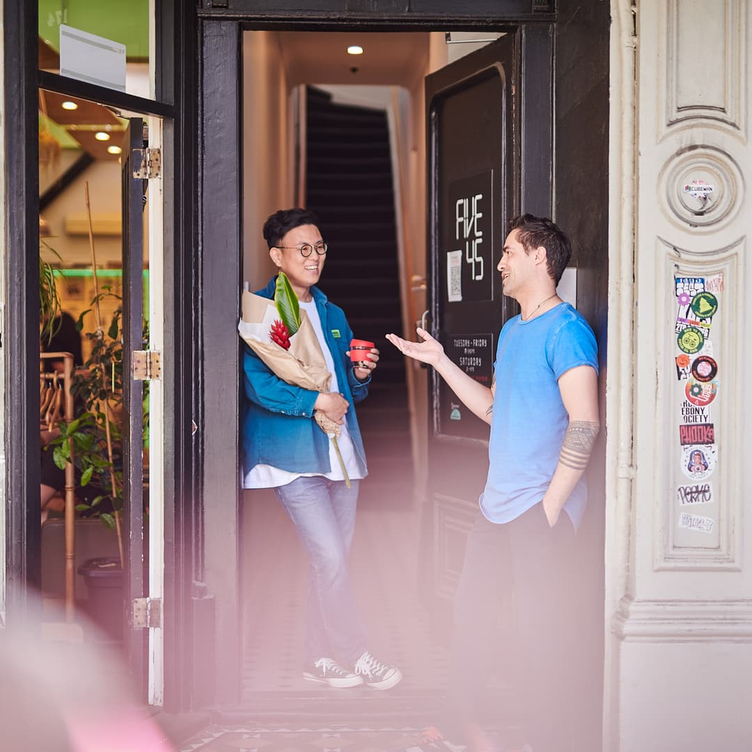 Two people outside Wellington shop front